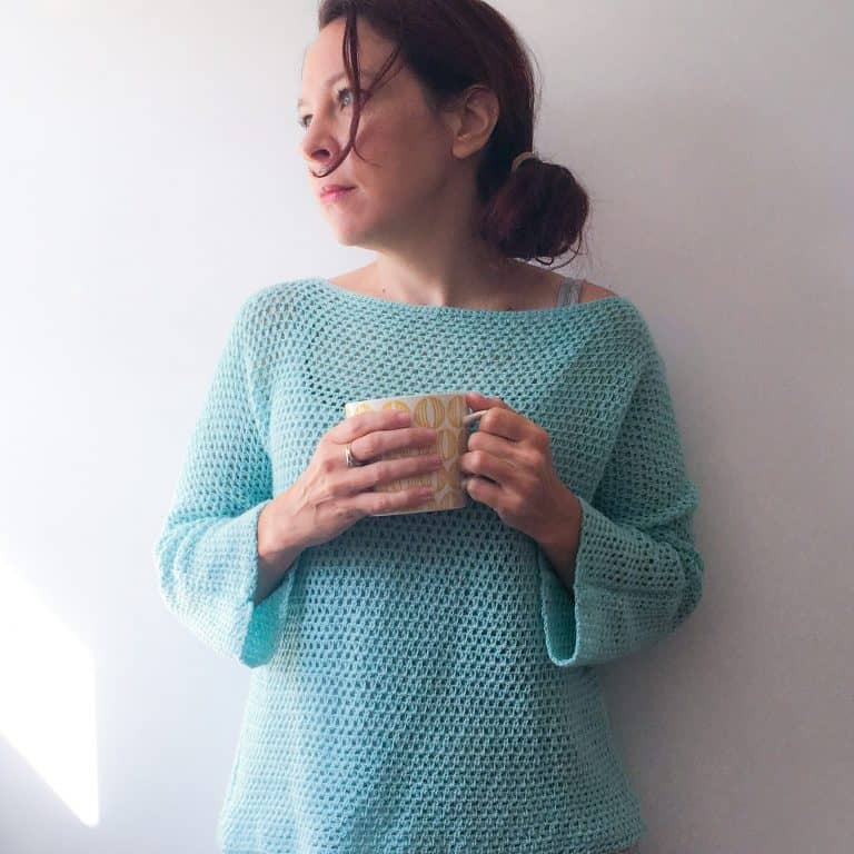 Woman in turquoise crochet sweater