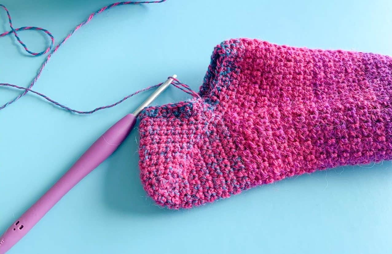 A crochet sock partially made showing the heel construction