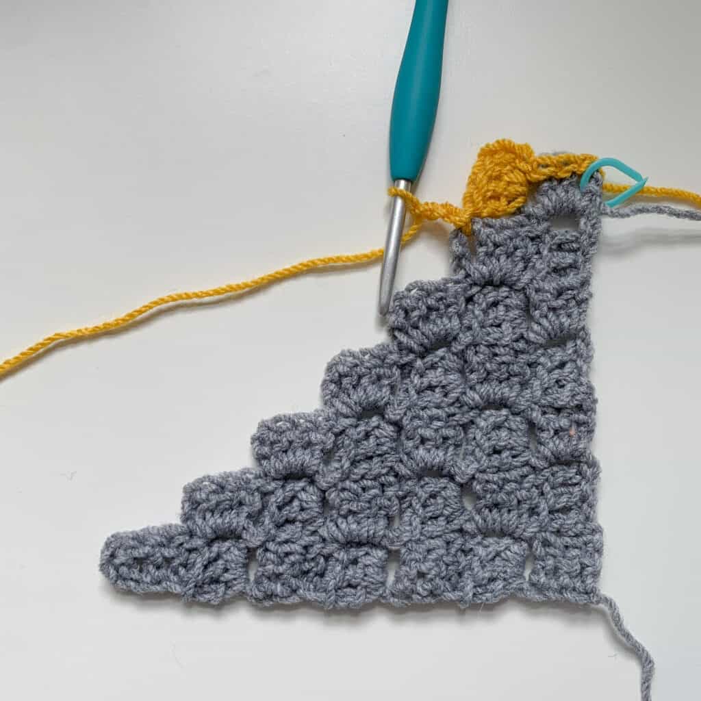 First block made in yellow yarn to show how to crochet a corner to corner rectangle.
