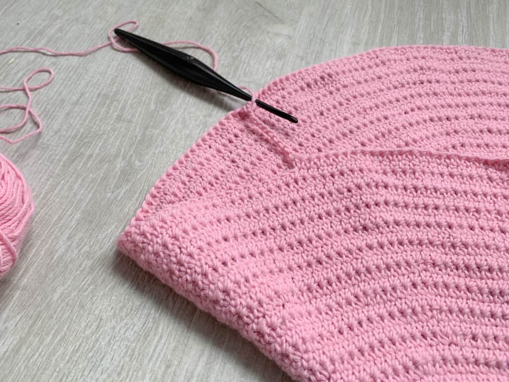 A process shot of the yoke splitting row of a top down crochet cardigan.