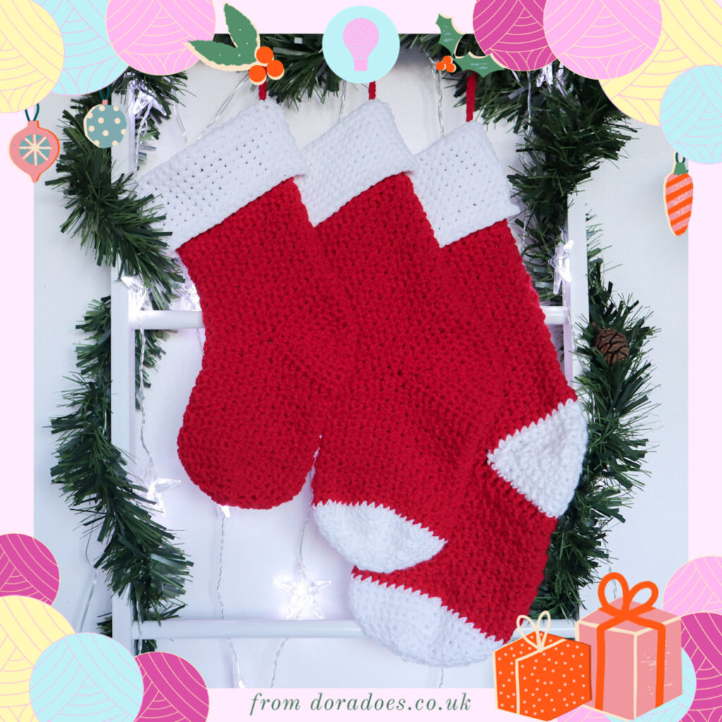 3 red crochet stockings hanging in the centre of a festive scene with dora does branded graphic framing the image.