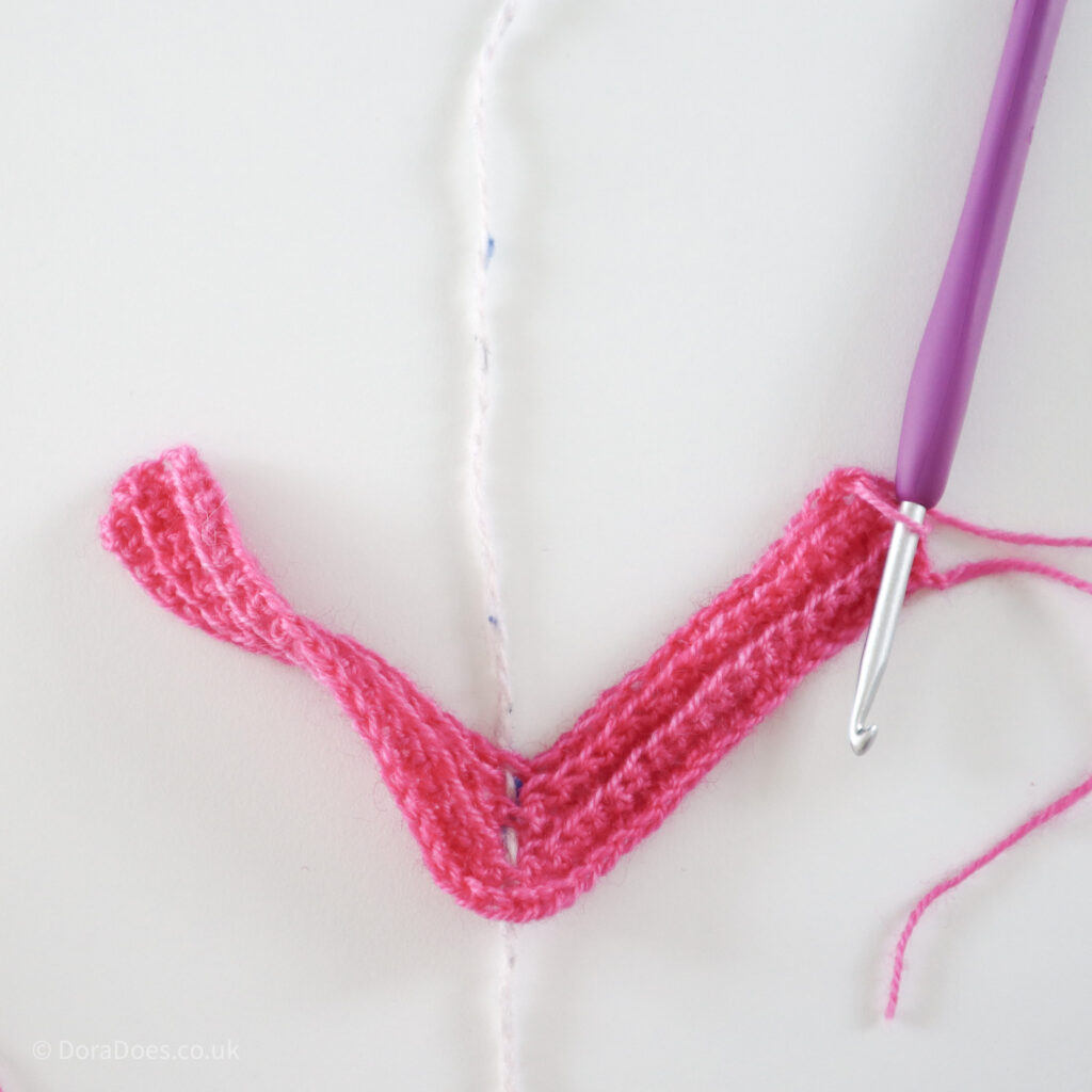 Crochet mitred square tutorial using pink yarn and a 4mm crochet hook, show after 5 rows: Step 9.