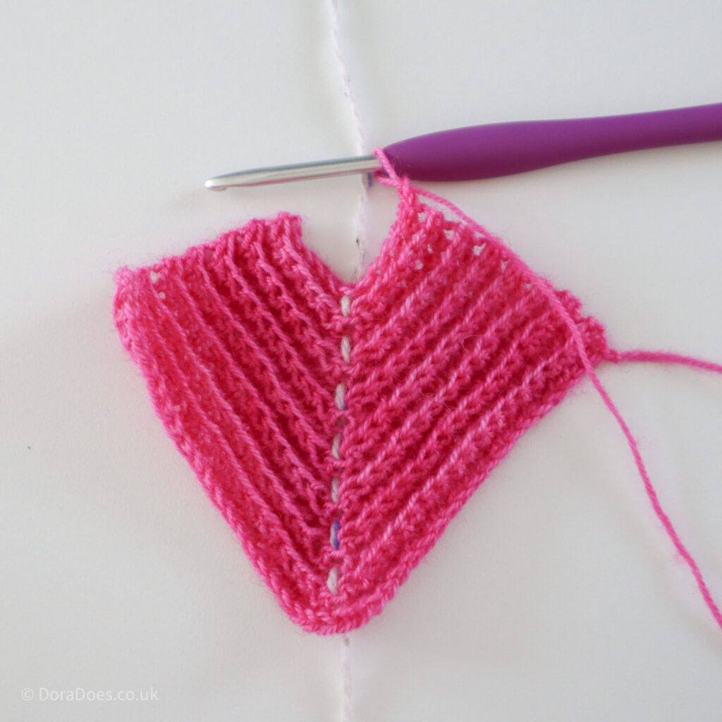 Crochet mitred square tutorial using pink yarn and a 4mm crochet hook, with only 3 rows still to work: Step 14.