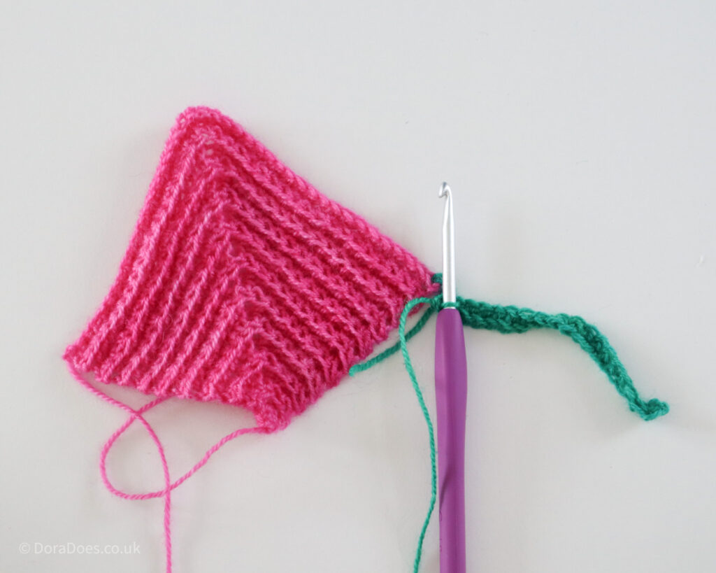 The first row of joining a crochet mitred square to another square as you go.