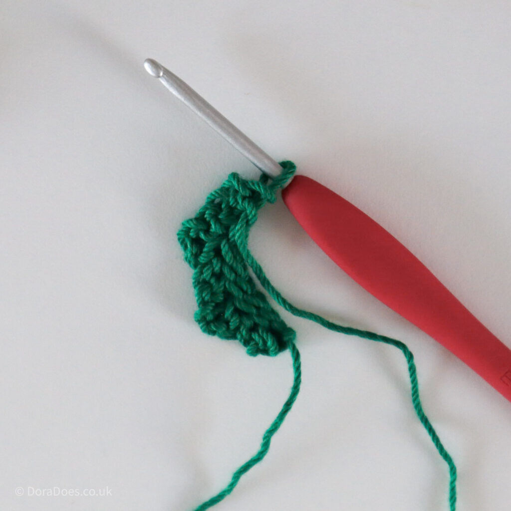 Crochet Holly Leaf tutorial showing working around the top of the leaf.