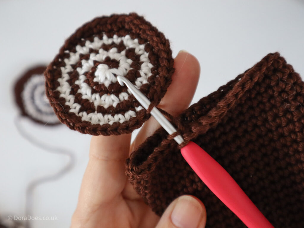 A close up of the first end being attached to the body of a crochet log.